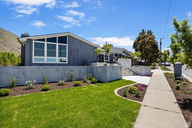 177 S Canyon Ave, Springville, UT 84663 - view of home's exterior with a yard and a chimney