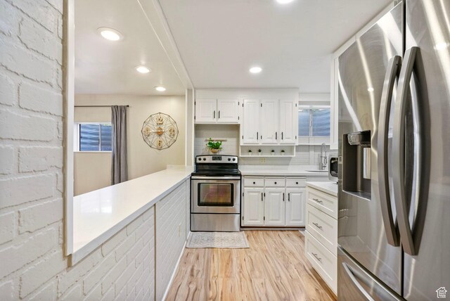 177 S Canyon Ave, Springville, UT 84663 - kitchen featuring appliances with stainless steel finishes, light wood-style floors, light countertops, white cabinets, and recessed lighting
