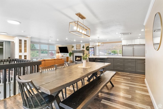 177 S Canyon Ave, Springville, UT 84663 - dining room with plenty of natural light, a warm lit fireplace, light wood-style flooring, recessed lighting, and baseboards