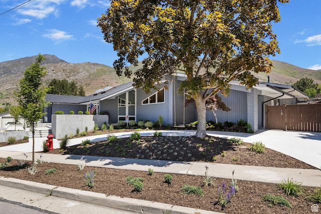 177 S Canyon Ave, Springville, UT 84663 - mid-century home featuring a mountain view, curved driveway, brick siding, and a gate