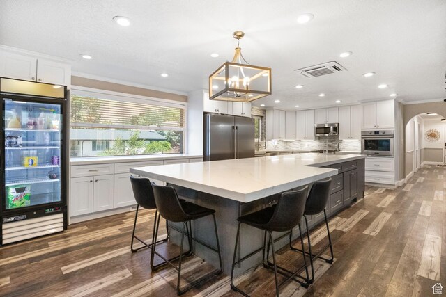 177 S Canyon Ave, Springville, UT 84663 - kitchen with appliances with stainless steel finishes, wine cooler, ornamental molding, white cabinetry, and decorative backsplash