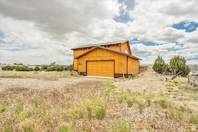9911 S Antelope Xing, Duchesne, UT 84021 - view of home's exterior with a garage, driveway, and an outbuilding