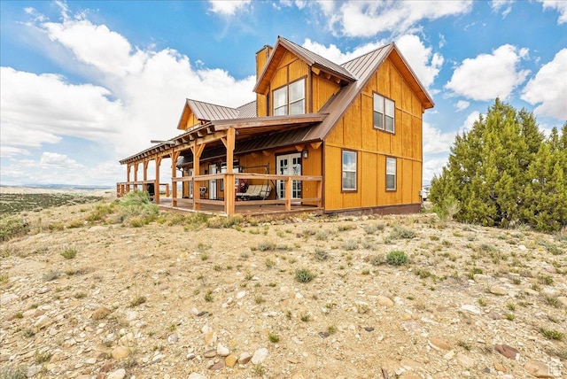 9911 S Antelope Xing, Duchesne, UT 84021 - rear view of house featuring a chimney, metal roof, a deck, and a standing seam roof