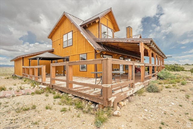 9911 S Antelope Xing, Duchesne, UT 84021 - rear view of property featuring metal roof, a deck, and a chimney