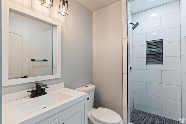 4203 S College Dr E, Ogden, UT 84403 - full bathroom featuring toilet, a tile shower, and vanity