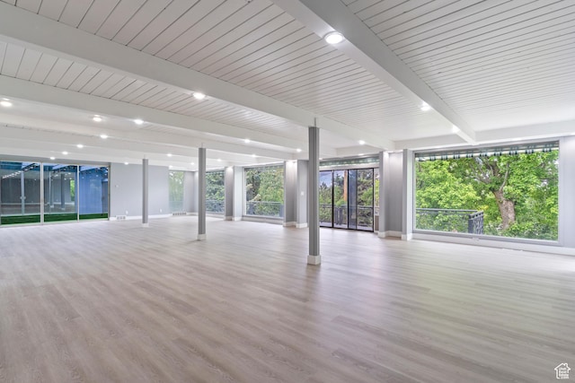 4203 S College Dr E, Ogden, UT 84403 - unfurnished living room with beamed ceiling, wood finished floors, baseboards, and plenty of natural light