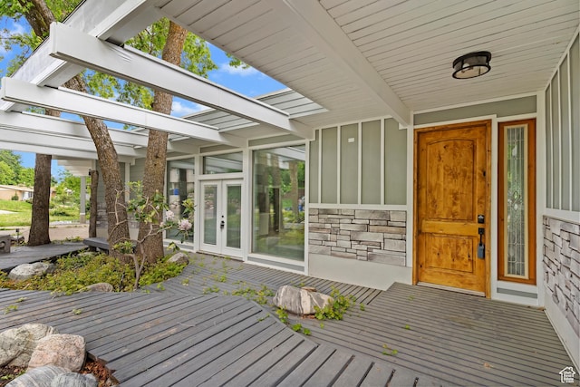 4203 S College Dr E, Ogden, UT 84403 - doorway to property featuring board and batten siding, stone siding, and a wooden deck