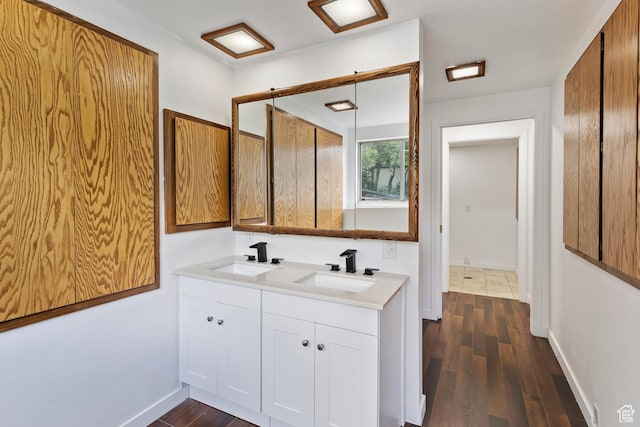 4203 S College Dr E, Ogden, UT 84403 - bathroom featuring double vanity, wood finished floors, and baseboards
