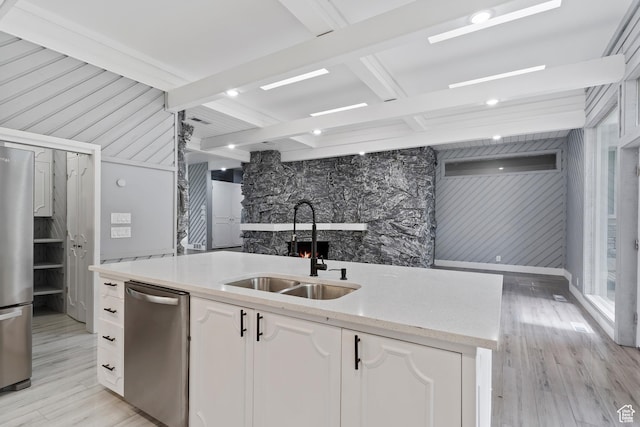 4203 S College Dr E, Ogden, UT 84403 - kitchen with appliances with stainless steel finishes, a sink, light wood-style floors, white cabinets, and beam ceiling