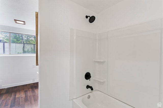 4203 S College Dr E, Ogden, UT 84403 - bathroom featuring shower / bathtub combination, wood finished floors, and baseboards