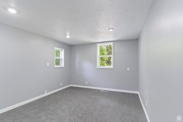 4203 S College Dr E, Ogden, UT 84403 - empty room featuring a textured ceiling, baseboards, dark carpet, and recessed lighting