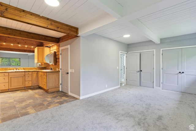 4203 S College Dr E, Ogden, UT 84403 - kitchen with carpet floors, beamed ceiling, baseboards, light brown cabinets, and a sink