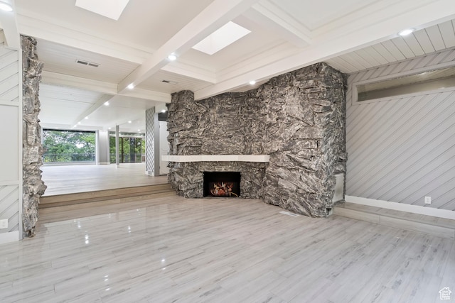 4203 S College Dr E, Ogden, UT 84403 - unfurnished living room with beam ceiling, a stone fireplace, and wood finished floors