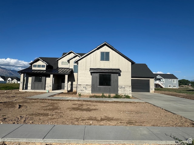 1234 N 4950 W, Plain City, UT 84404 - modern inspired farmhouse with a standing seam roof, driveway, metal roof, stone siding, and a garage