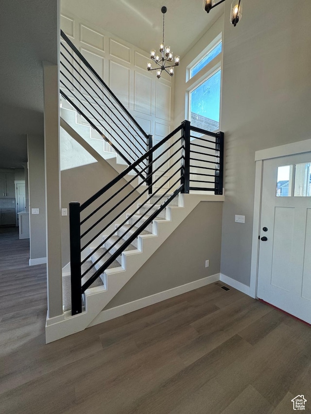 1234 N 4950 W, Plain City, UT 84404 - entrance foyer with a chandelier, wood finished floors, baseboards, stairs, and a high ceiling