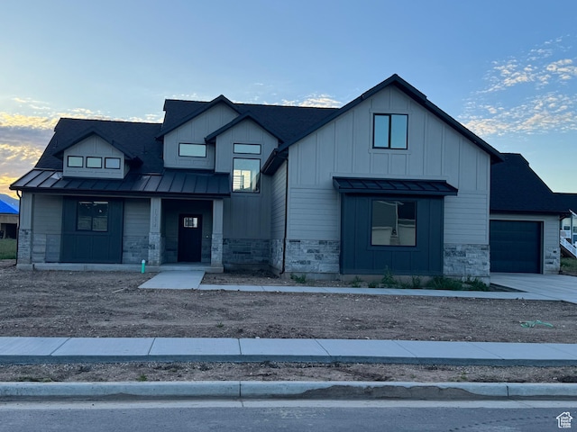 1234 N 4950 W, Plain City, UT 84404 - modern farmhouse style home featuring a standing seam roof, stone siding, board and batten siding, metal roof, and a porch