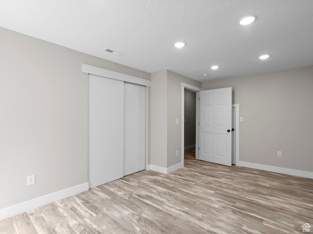 3095 W 8525 S, West Jordan, UT 84088 - unfurnished bedroom with wood finished floors, baseboards, recessed lighting, and a closet