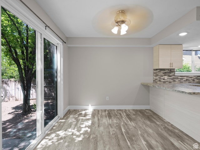 3095 W 8525 S, West Jordan, UT 84088 - unfurnished dining area with light wood finished floors, ceiling fan, and baseboards
