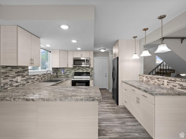 3095 W 8525 S, West Jordan, UT 84088 - kitchen featuring electric stove, stainless steel microwave, a sink, freestanding refrigerator, and a peninsula