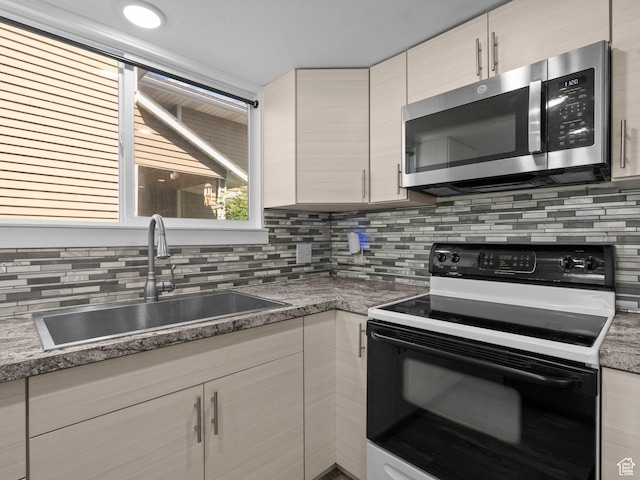 3095 W 8525 S, West Jordan, UT 84088 - kitchen with range with electric stovetop, stainless steel microwave, a sink, and tasteful backsplash