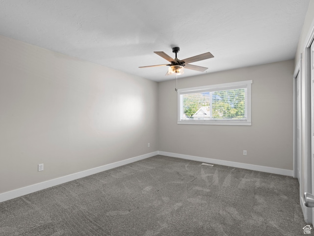 3095 W 8525 S, West Jordan, UT 84088 - spare room featuring dark colored carpet, baseboards, and a ceiling fan
