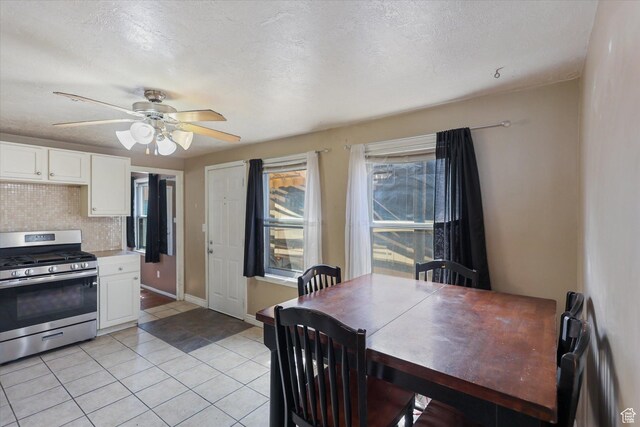 80 S 400 E, Clearfield, UT 84015 - dining room with light tile patterned flooring, a ceiling fan, a textured ceiling, and baseboards