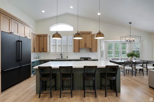 1446 E Anvil Dr, Draper, UT 84020 - kitchen featuring high end black refrigerator, backsplash, light countertops, a sink, and high vaulted ceiling