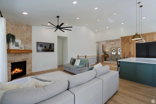 1446 E Anvil Dr, Draper, UT 84020 - living room with light wood finished floors, a ceiling fan, high vaulted ceiling, a stone fireplace, and recessed lighting