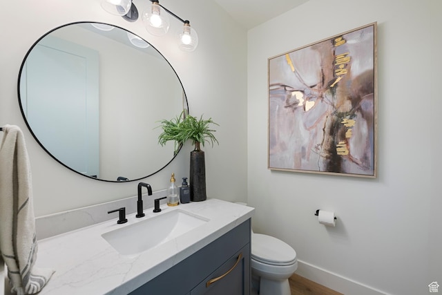 1446 E Anvil Dr, Draper, UT 84020 - bathroom with vanity, toilet, wood finished floors, and baseboards