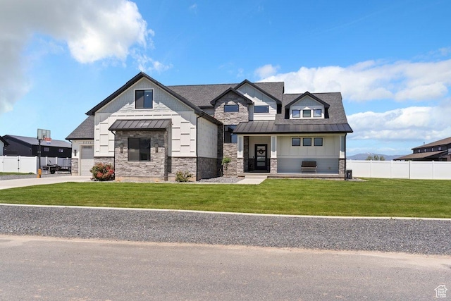 5376 W 560 N, Warren, UT 84404 - view of front of house with a standing seam roof, stone siding, metal roof, and concrete driveway