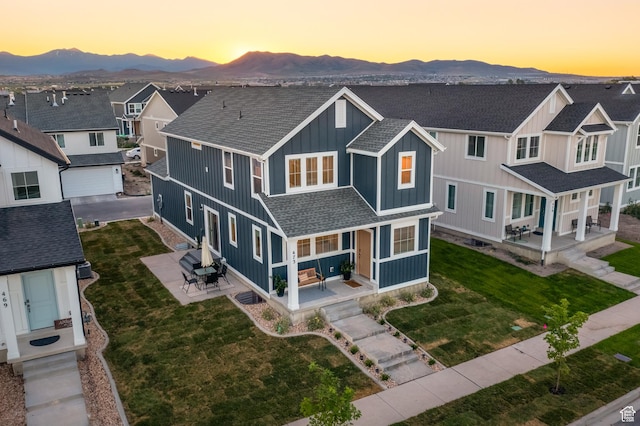 473 N Northshore Dr, Saratoga Springs, UT 84045 - view of front of house featuring a mountain view, a shingled roof, and a front lawn