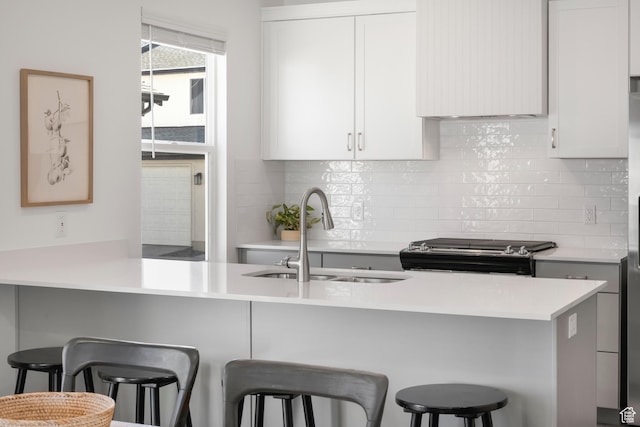 473 N Northshore Dr, Saratoga Springs, UT 84045 - kitchen featuring a sink, stainless steel range, tasteful backsplash, and light countertops