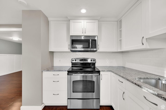 1543 Mulberry Way, Sandy, UT 84093 - kitchen featuring stainless steel appliances, white cabinets, light stone countertops, dark wood finished floors, and wainscoting