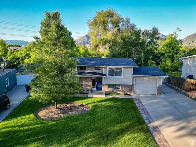 1543 Mulberry Way, Sandy, UT 84093 - view of front facade featuring concrete driveway, a garage, stone siding, and a mountain view