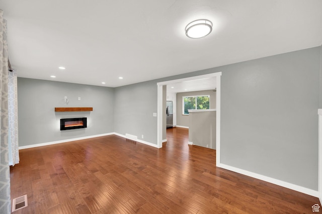 1543 Mulberry Way, Sandy, UT 84093 - unfurnished living room with a glass covered fireplace, wood finished floors, baseboards, and recessed lighting