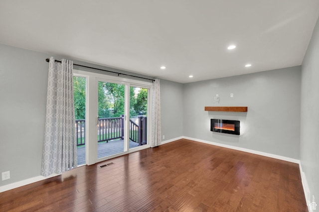1543 Mulberry Way, Sandy, UT 84093 - unfurnished living room with a glass covered fireplace, wood finished floors, baseboards, and recessed lighting