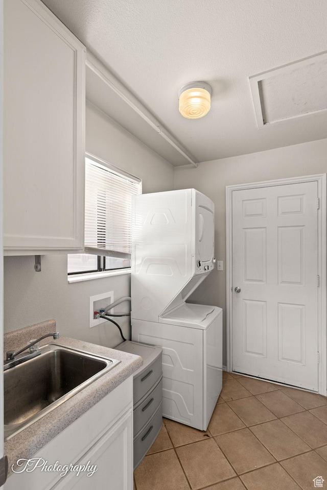 840 S 400 E Unit 46, St George, UT 84770 - laundry room with stacked washer / dryer, light tile patterned floors, and attic access