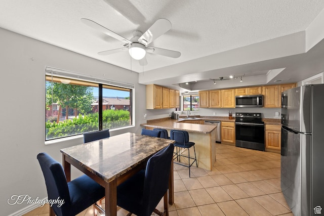 840 S 400 E Unit 46, St George, UT 84770 - kitchen with stainless steel appliances, a peninsula, a kitchen breakfast bar, rail lighting, and a textured ceiling