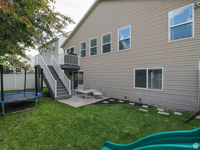 67 N Archmore St, Saratoga Springs, UT 84043 - rear view of house with a playground, a patio area, a trampoline, stairway, and a deck