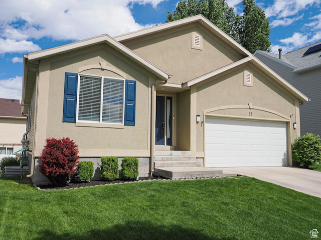 67 N Archmore St, Saratoga Springs, UT 84043 - view of front of house with an attached garage, stucco siding, driveway, and a front yard