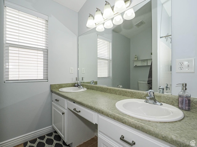 67 N Archmore St, Saratoga Springs, UT 84043 - full bathroom featuring double vanity, toilet, tile patterned flooring, and baseboards