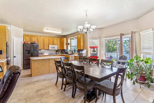 3681 W 775 N, Layton, UT 84041 - dining space with a chandelier, a textured ceiling, and light tile patterned floors