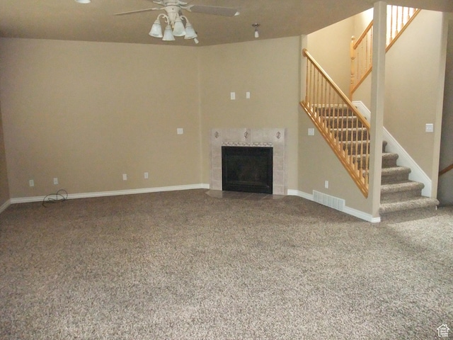3681 W 775 N, Layton, UT 84041 - unfurnished living room featuring stairs, ceiling fan, carpet flooring, a tiled fireplace, and baseboards