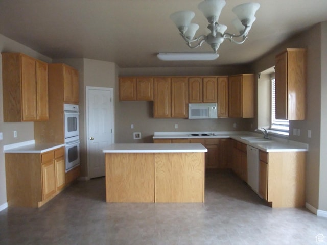3681 W 775 N, Layton, UT 84041 - kitchen featuring white appliances, a kitchen island, a sink, light countertops, and a chandelier