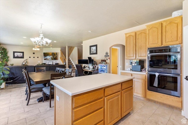 3681 W 775 N, Layton, UT 84041 - kitchen with double oven, arched walkways, a chandelier, a center island, and light brown cabinets