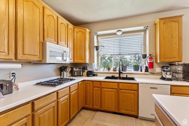 3681 W 775 N, Layton, UT 84041 - kitchen featuring white appliances, a sink, light countertops, light tile patterned floors, and a textured ceiling