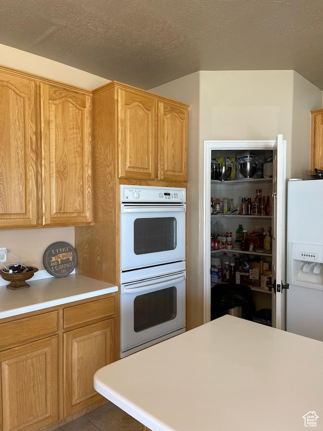 3681 W 775 N, Layton, UT 84041 - kitchen featuring white appliances, light countertops, tile patterned floors, and a textured ceiling