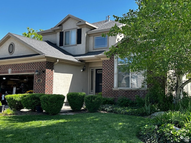 3681 W 775 N, Layton, UT 84041 - traditional-style house featuring stucco siding, brick siding, a front lawn, a shingled roof, and a garage
