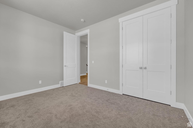 2711 S Allison Way Unit 101, Syracuse, UT 84075 - unfurnished bedroom featuring carpet, baseboards, and a closet
