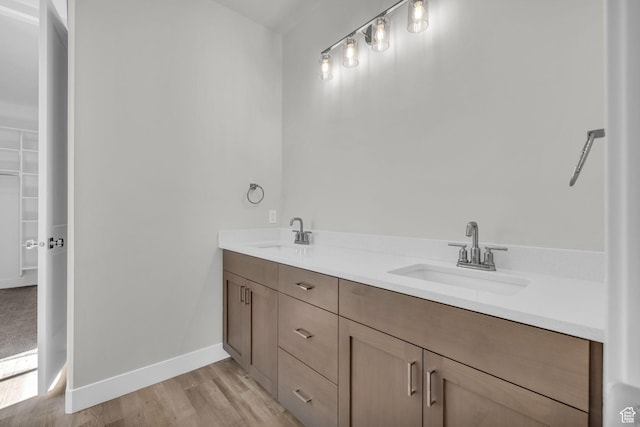 2711 S Allison Way Unit 101, Syracuse, UT 84075 - full bathroom with double vanity, wood finished floors, and baseboards